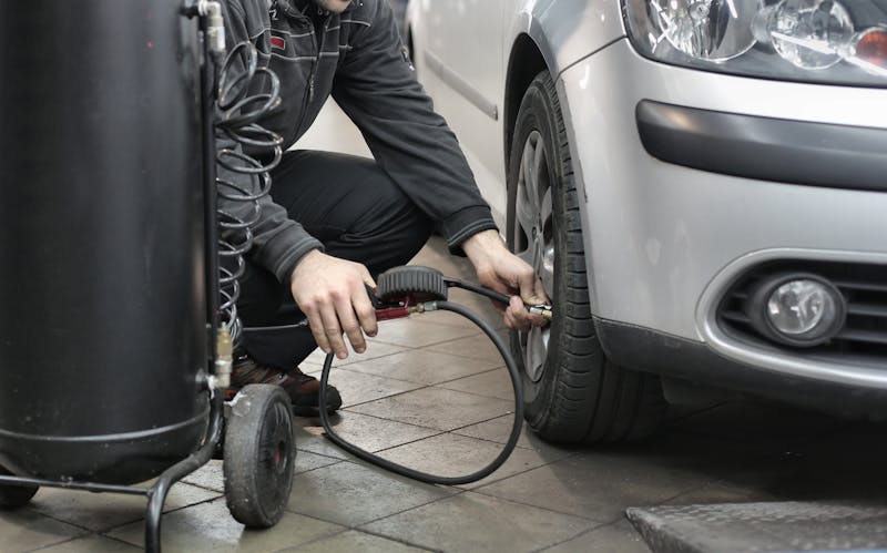 Dismantler inspecting car parts