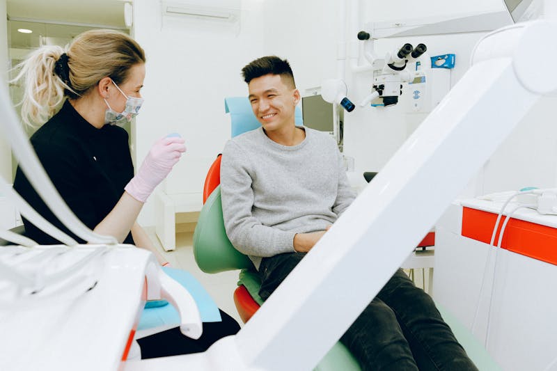 Dentist consulting with patient