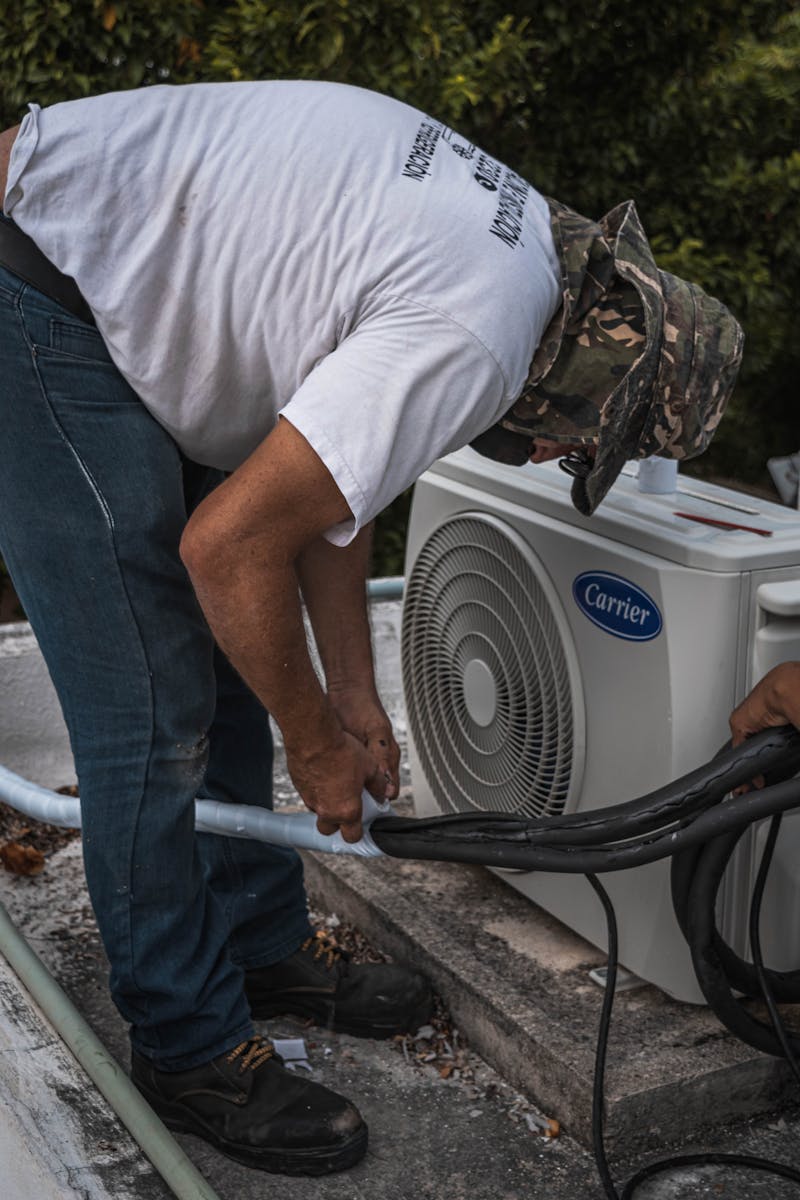 HVAC technician servicing air conditioning unit