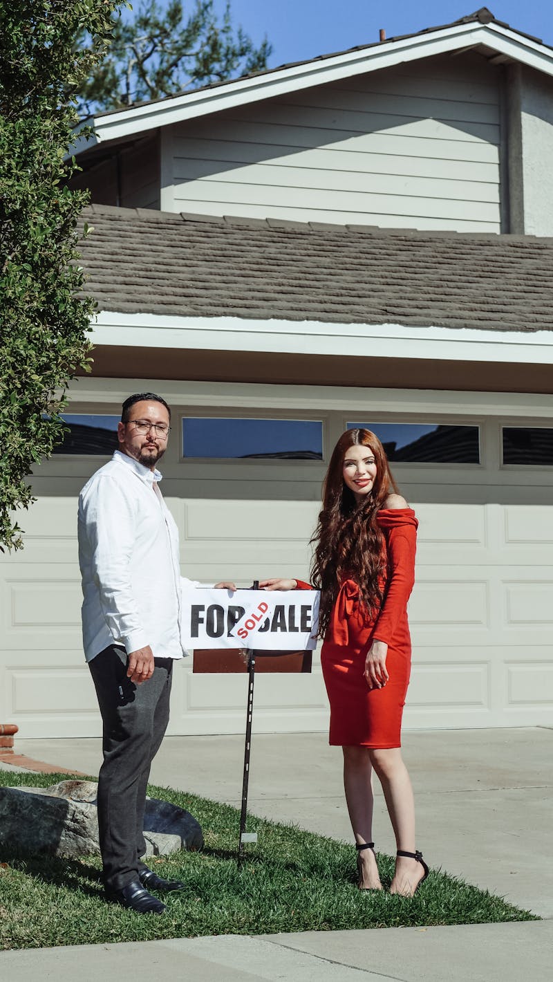 Couple receiving house keys from broker