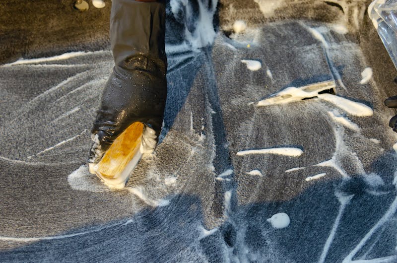 Spray painter in booth